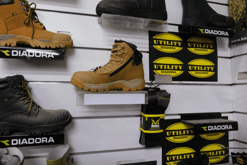 Display of work boots and protective gear for rural and farm workers, available at Murrumbateman Rural Supplies